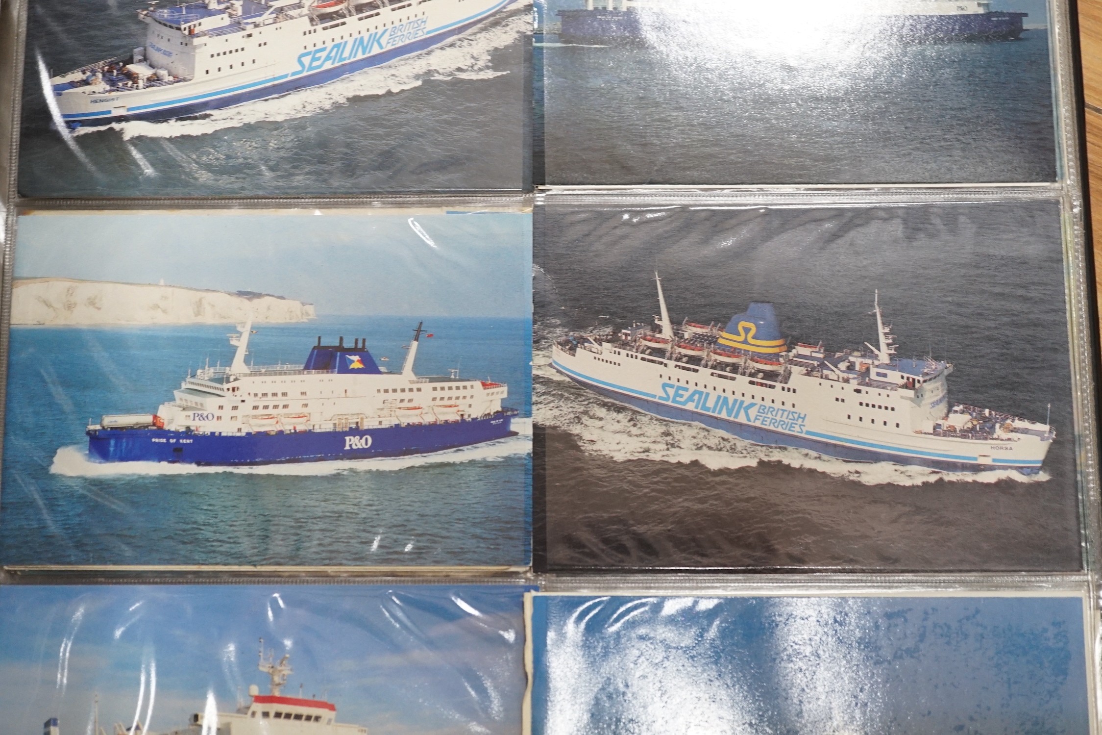 Three postcard albums with postcards relating to ships, royalty, art, trains, buses, motorcycles etc